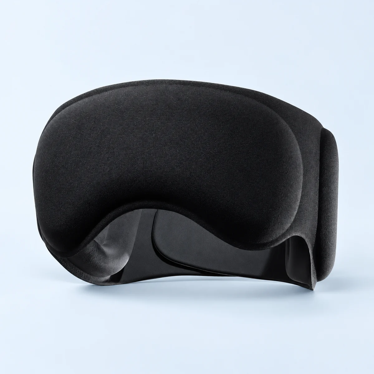 Black contoured sleep mask with a shaped nose area and broad padded ear cushions, viewed from the front