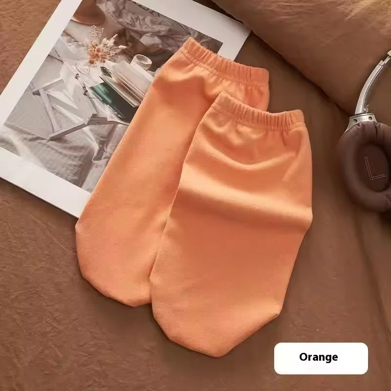 Orange sleep socks with broad foot shape and gathered openings
