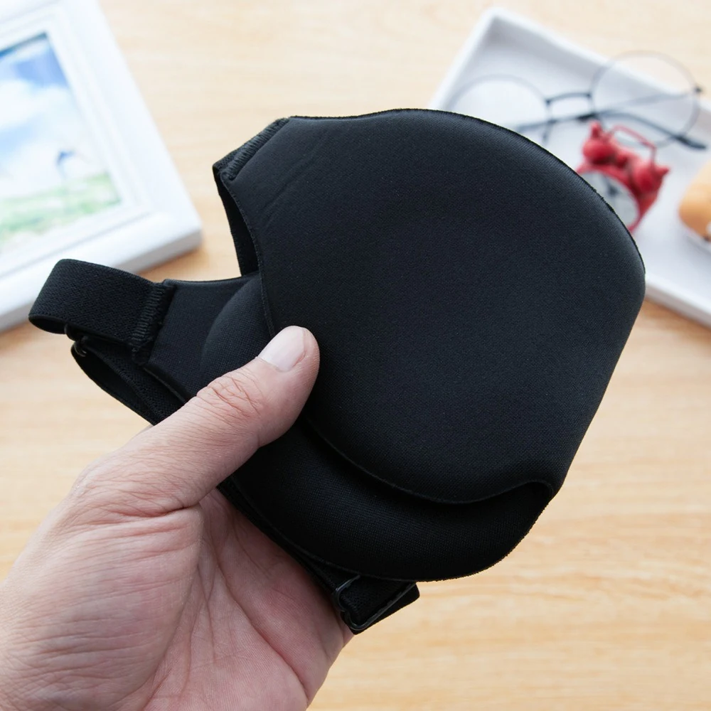 Hand holding the black contoured mask to show its curved shape