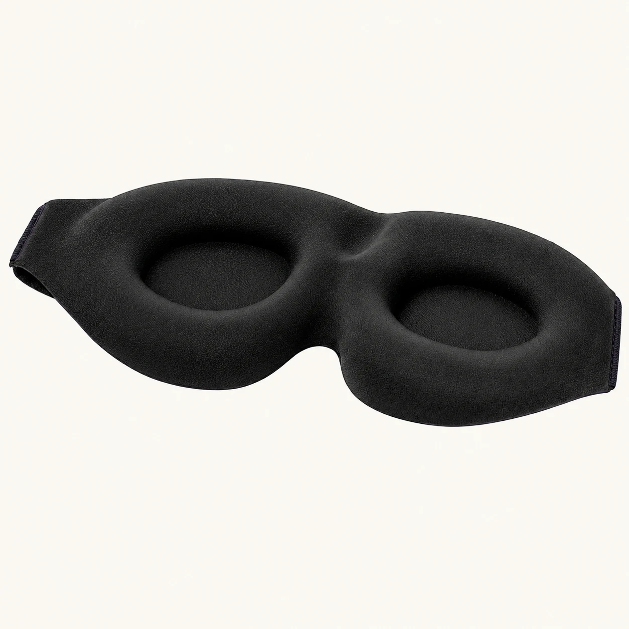Inner view of the black mask showing two padded eye recesses and a curved nose edge